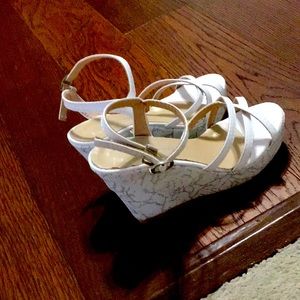 They are white wedges with a strap in ankle